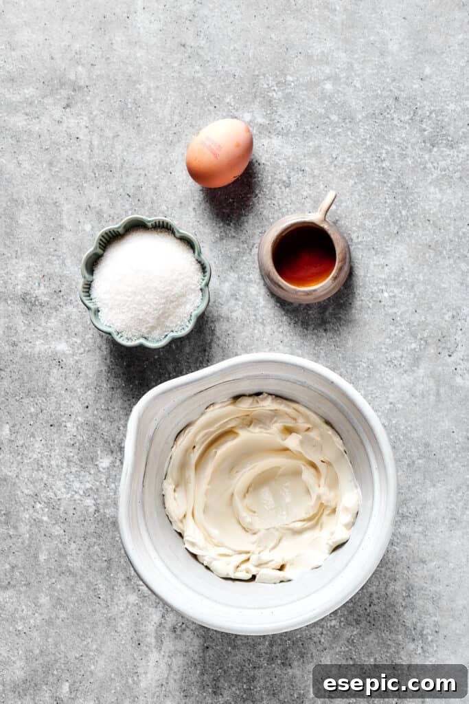 Making the cream cheese swirl mixture in a white mixing bowl with a hand mixer.