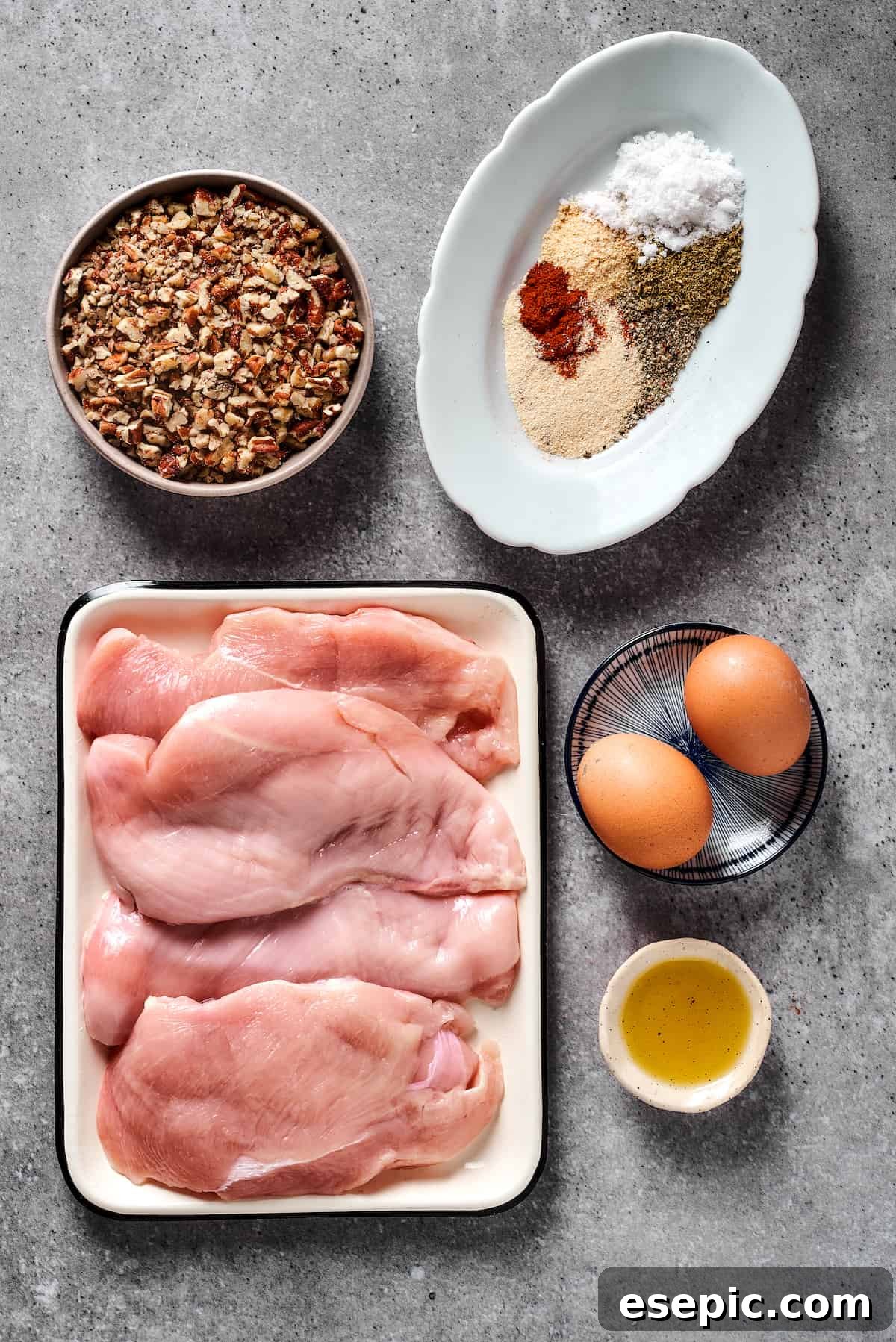 From top left: Chopped pecans, spices, chicken breast, eggs, olive oil.