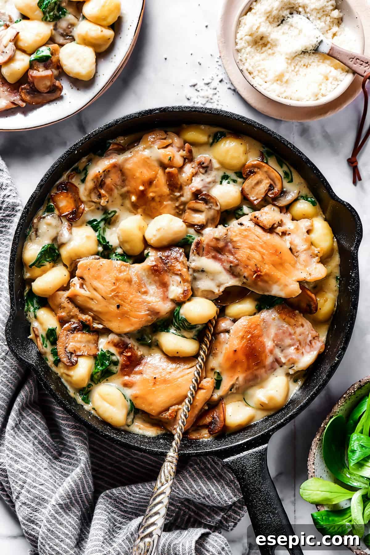 Creamy Chicken & Gnocchi - A Delicious and Easy Skillet Meal Creamy chicken and gnocchi in a cast-iron skillet, ready to be served.