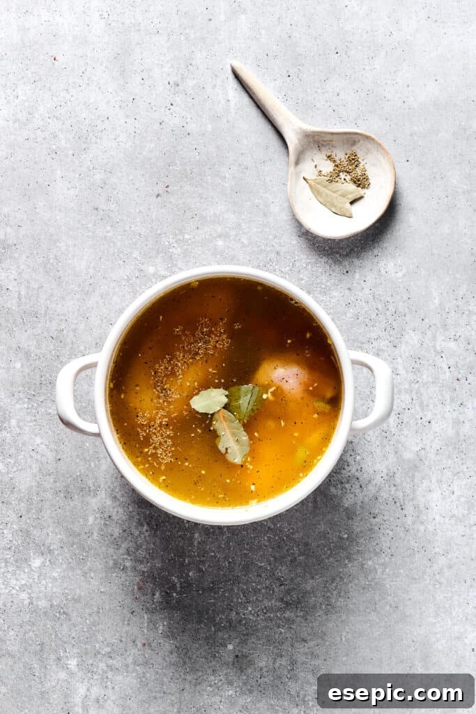 Simple Comfort Chicken and Dumplings 4 Broth and herbs added to a soup pot.