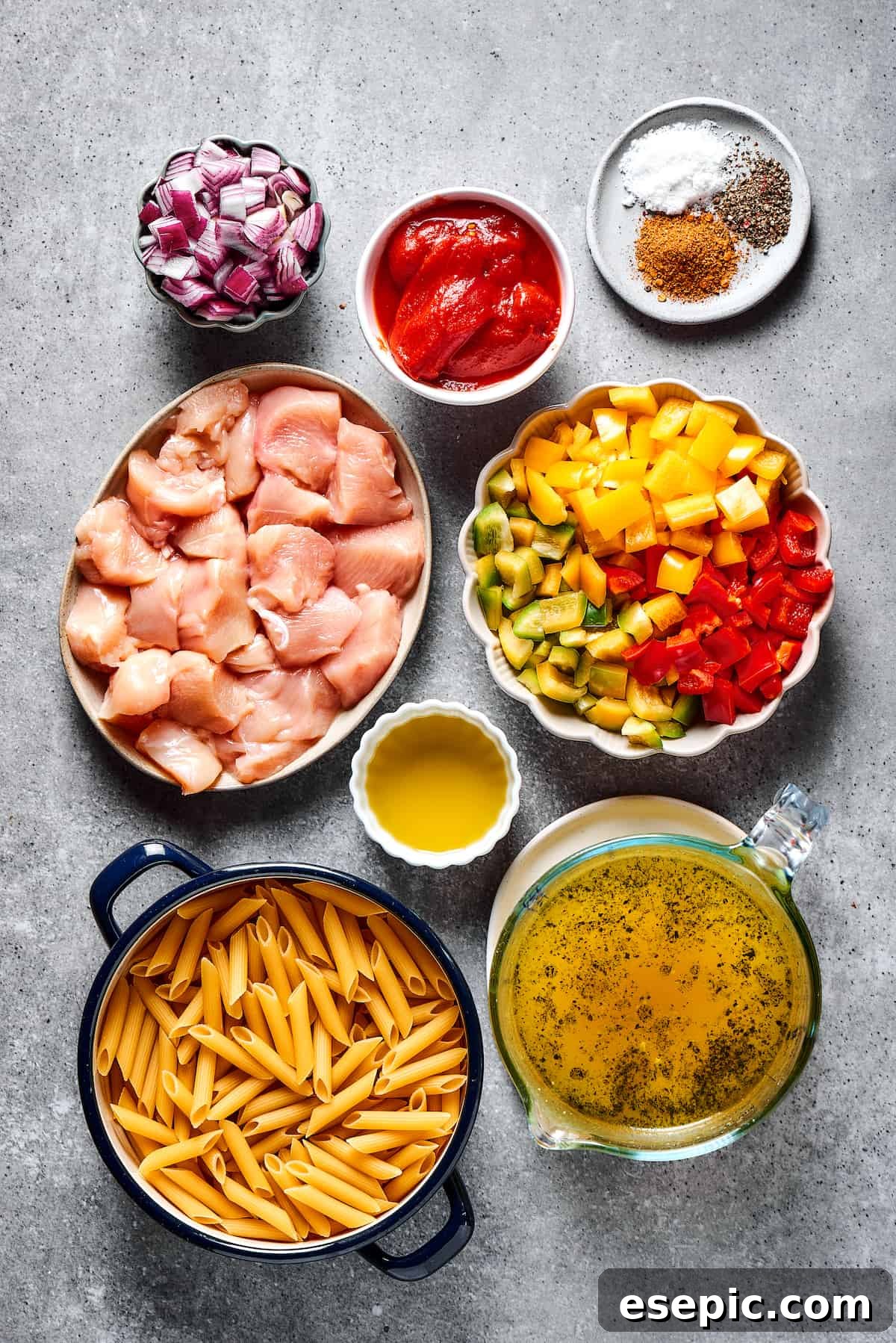 Chicken fajita pasta ingredients measured and arranged in small dishes on a work surface.
