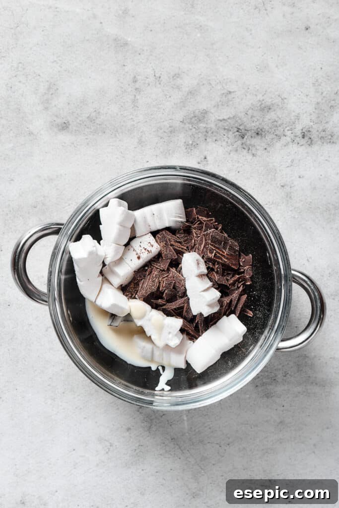 Irresistible Chocolate Crispy Bars 8 A heat-resistant bowl of melting chocolate and marshmallows over a pot of simmering water, creating a smooth topping.