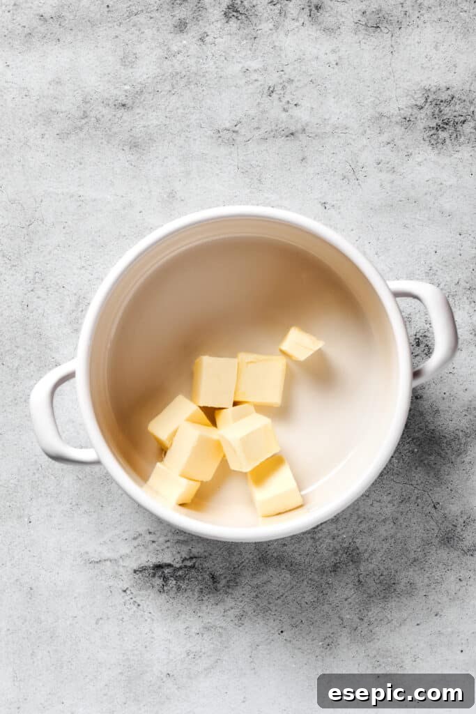 Irresistible Chocolate Crispy Bars 2 Butter melting in a pot on a stovetop, forming a golden liquid.