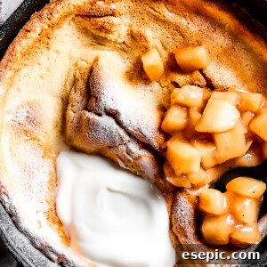 A skillet pancake with apples and creamy topping.
