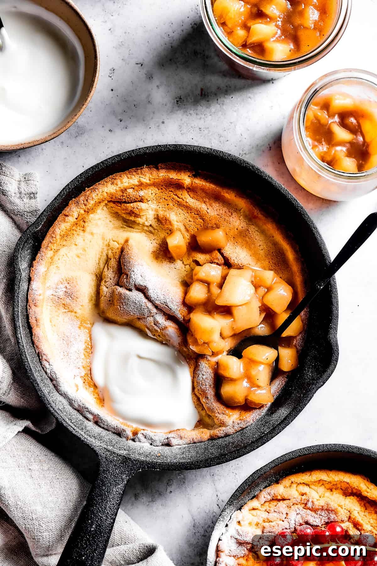 Overhead shot of German pancake in a cast iron skillet.