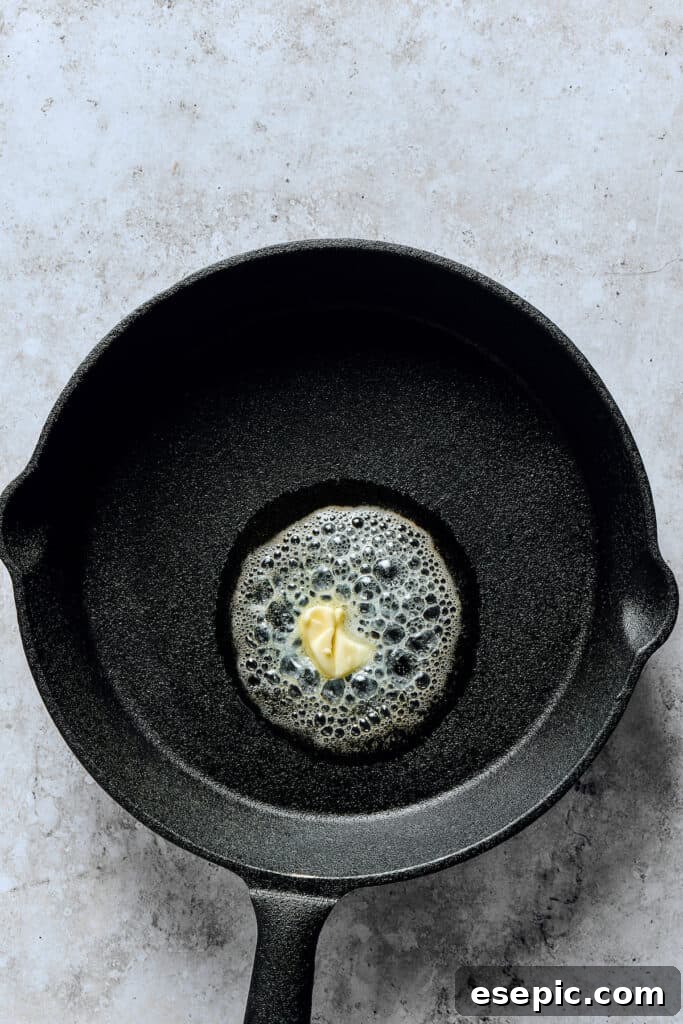 Melting butter in a skillet.