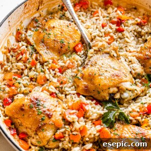 scooping out chicken thighs set on a bed of rice inside a white skillet