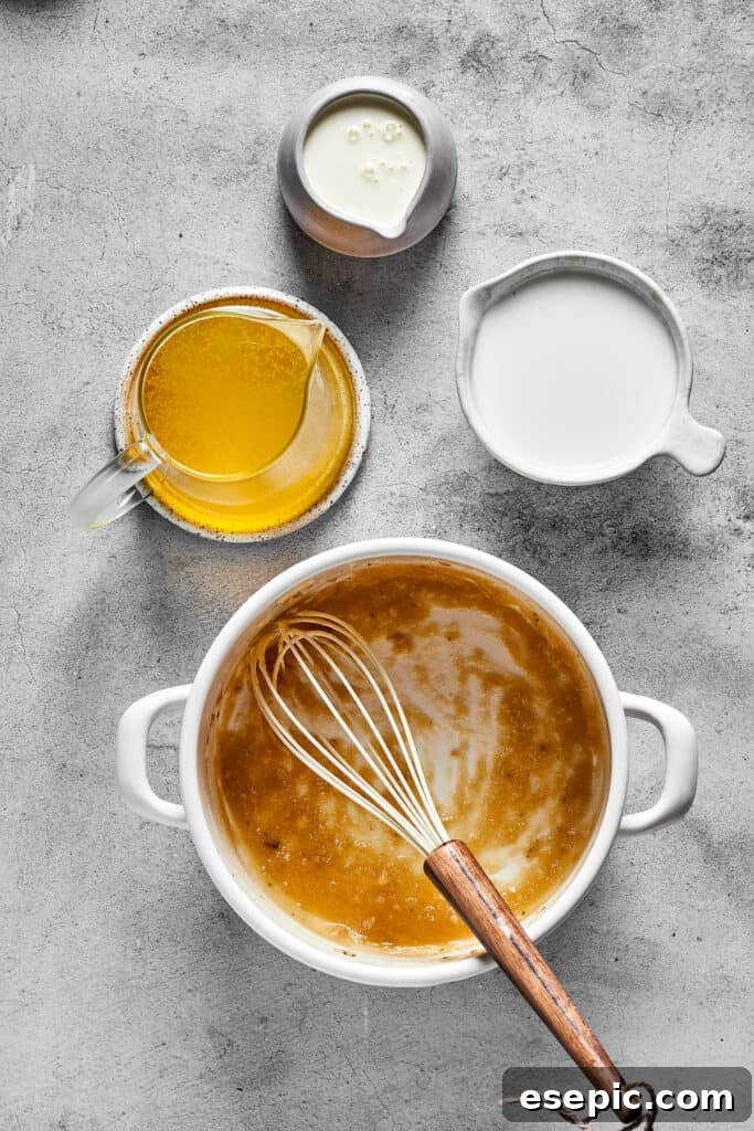 Whisking heavy cream into the sauce mixture, creating a smooth and luscious texture for the tetrazzini.