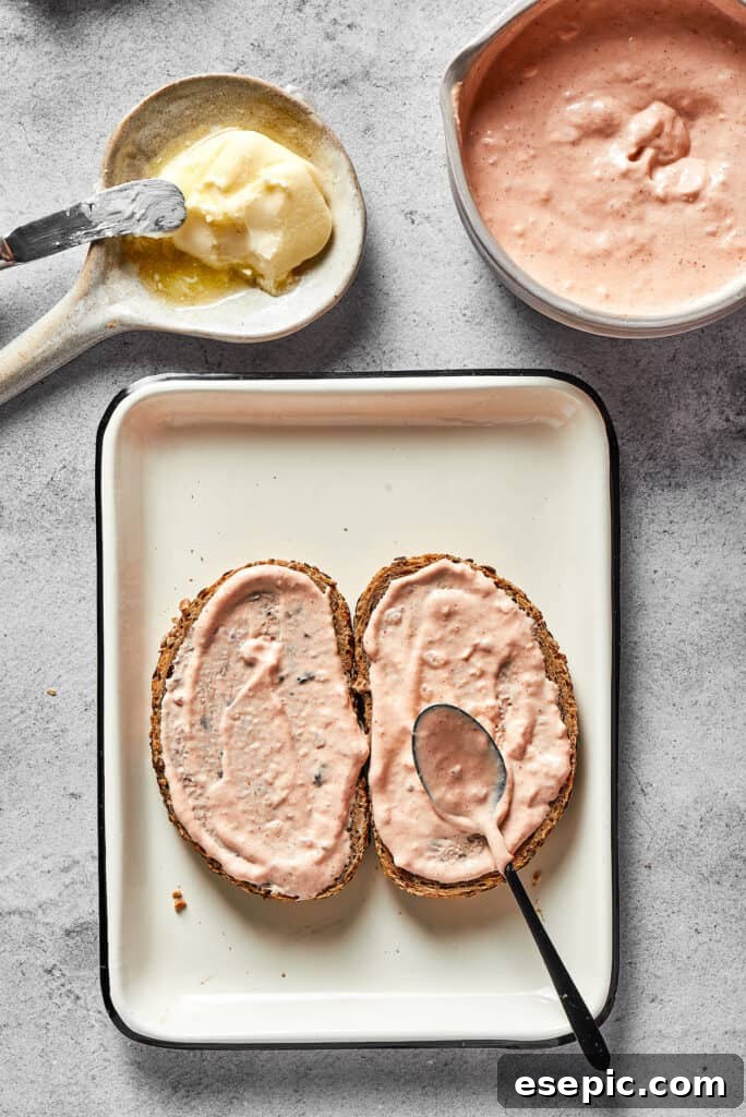Spreading Russian dressing thickly on bread.