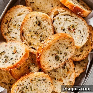 Seasoned bagel chips in a metal tin.