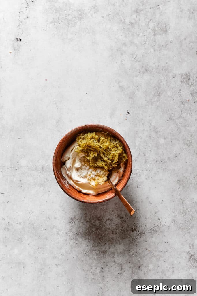 Serve cooled bagel chips with the prepared zesty cream cheese dip for an unforgettable snack! Dip ingredients in a small bowl.
