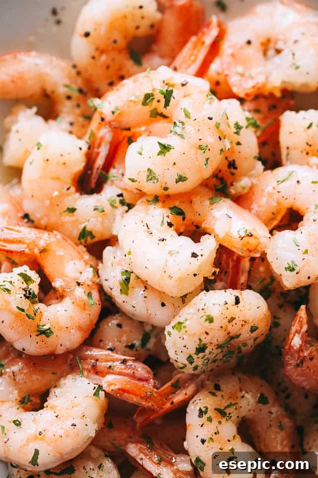 up close photo of cooked shrimp in a white skillet