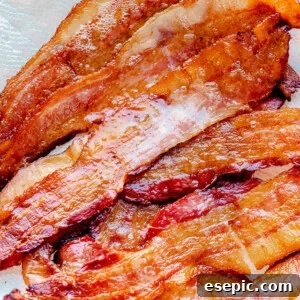Oven baked bacon on a paper towel.