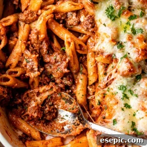 The Ultimate Cheesy Baked Ziti 8 Close-up of baked ziti in a baking dish with a golden, bubbly cheese top.
