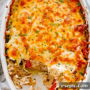 top view of chicken fajita casserole in an oval baking dish topped with melted cheese