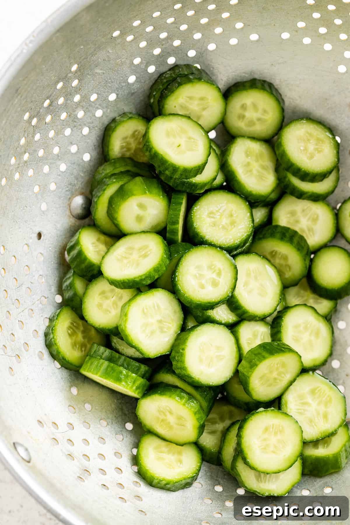 Rinsed and strained cucumbers after resting with salt, ensuring they are perfectly crisp and ready for the Jennifer Aniston salad.