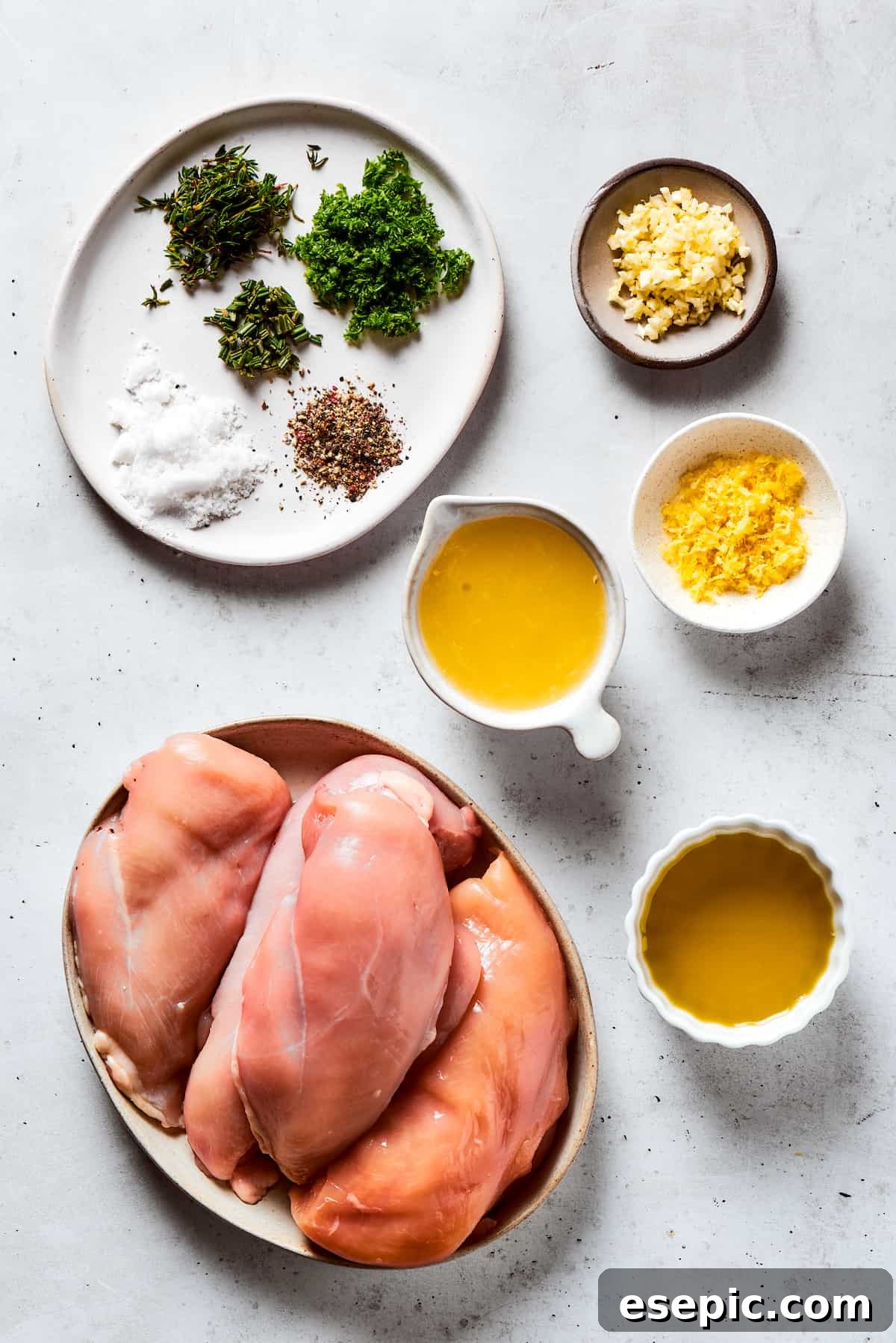 From top: Seasonings, garlic, lemon juice, chicken breasts, olive oil.