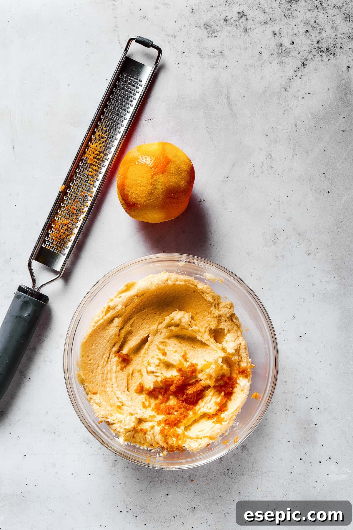 Sweet, buttery Orange Cookies have a light citrus taste and pretty pastel color - perfect for parties, cookie swaps, baby showers, and more! Adding orange zest to cookie dough.