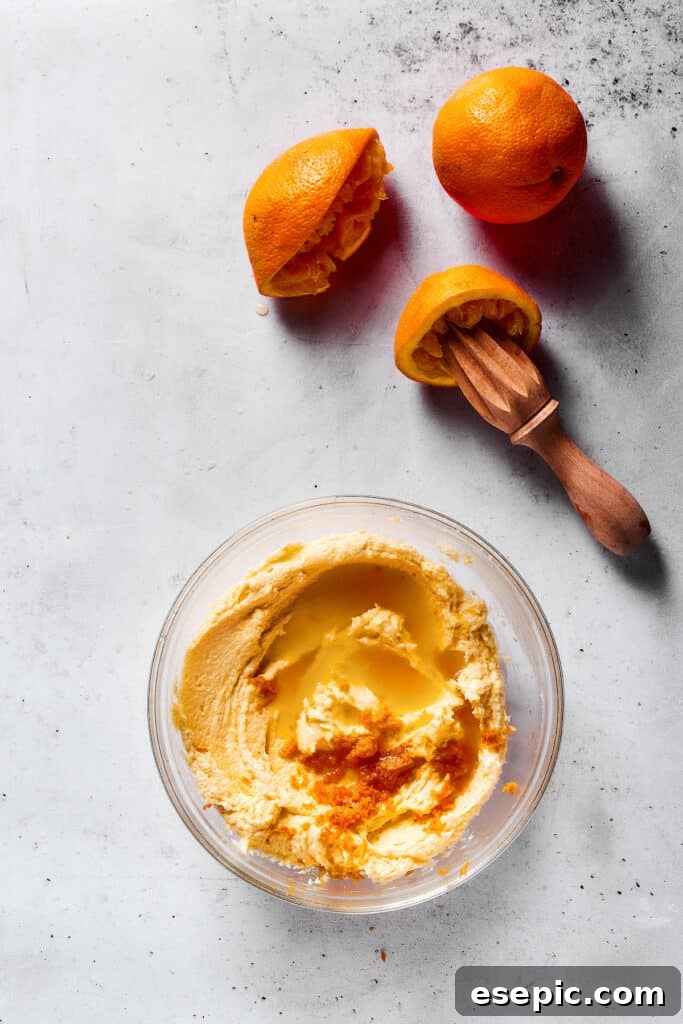 Sweet, buttery Orange Cookies have a light citrus taste and pretty pastel color - perfect for parties, cookie swaps, baby showers, and more! Adding orange juice to cokoie dough.