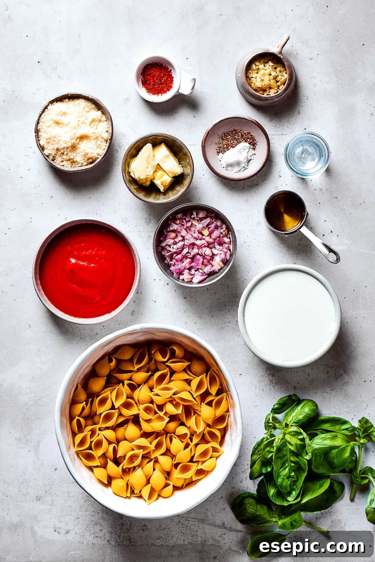 Gigi Hadid Pasta is an easy recipe that every busy cook should know! With tender pasta, red pepper flakes, and cream, it's total comfort food. Gigi Hadid pasta ingredients, including shells, tomato paste, cream, and seasonings, arranged on a work surface.