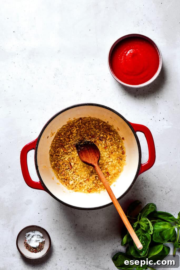 Gigi Hadid Pasta is an easy recipe that every busy cook should know! With tender pasta, red pepper flakes, and cream, it's total comfort food. Garlic and shallots cooking in a saucepan, releasing fragrant aromas.
