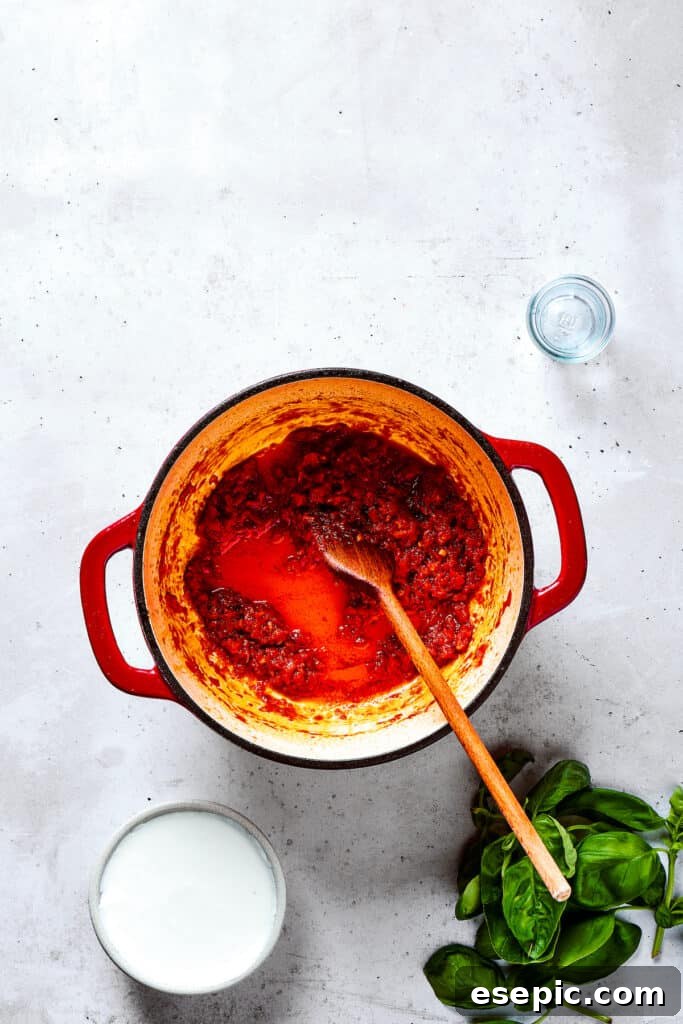 Gigi Hadid Pasta is an easy recipe that every busy cook should know! With tender pasta, red pepper flakes, and cream, it's total comfort food. Adding red pepper flakes and other seasonings to a pot of developing sauce.