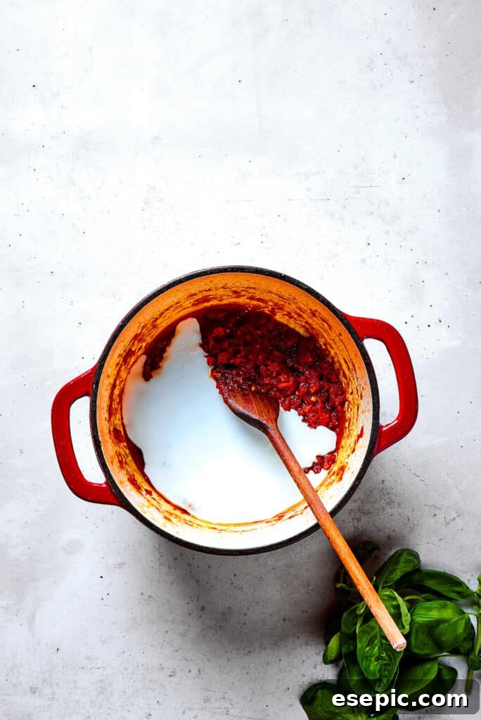 Gigi Hadid Pasta is an easy recipe that every busy cook should know! With tender pasta, red pepper flakes, and cream, it's total comfort food. Stirring heavy cream into a pot of simmering tomato sauce.
