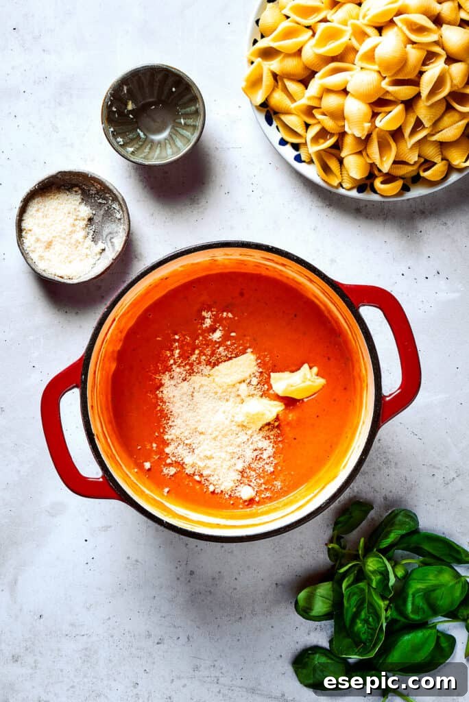 Gigi Hadid Pasta is an easy recipe that every busy cook should know! With tender pasta, red pepper flakes, and cream, it's total comfort food. Parmesan cheese being added to the rich vodka sauce in a skillet.