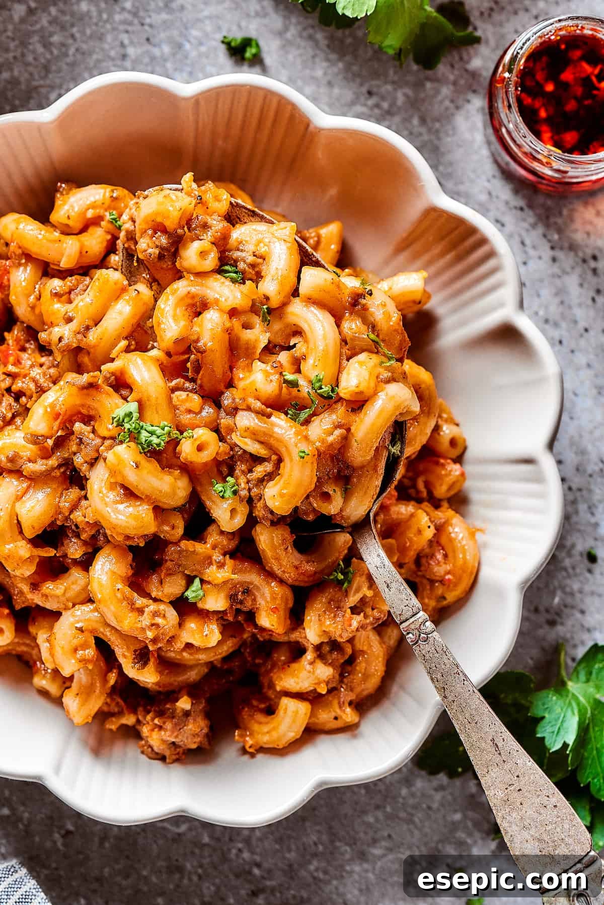 A steaming bowl of comforting cheeseburger pasta casserole, ready to be enjoyed as a hearty meal.