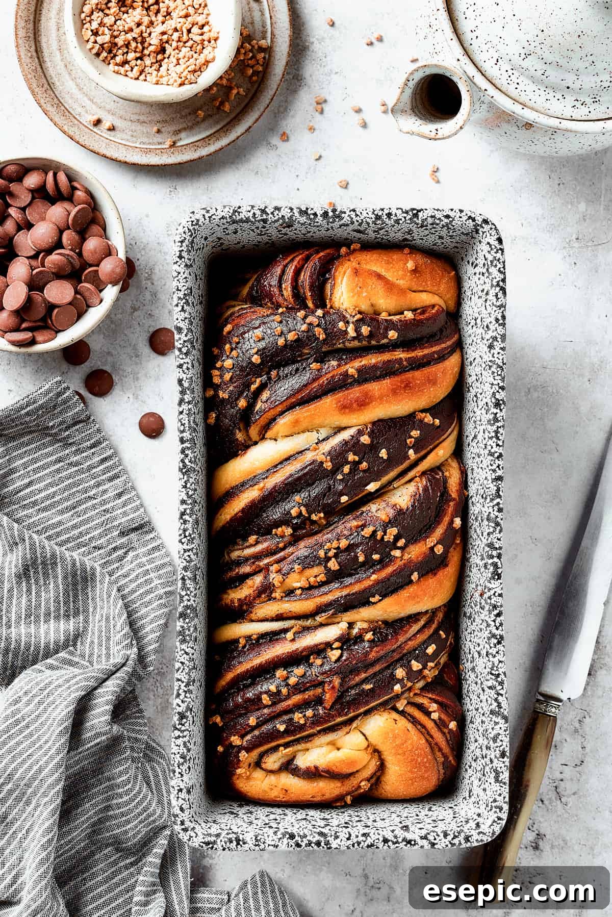 Sweet, puffy Chocolate Babka is an old-fashioned yeast bread swirled with layers of chocolate. Perfect for a special breakfast or dessert. A baked chocolate babka in a loaf pan.
