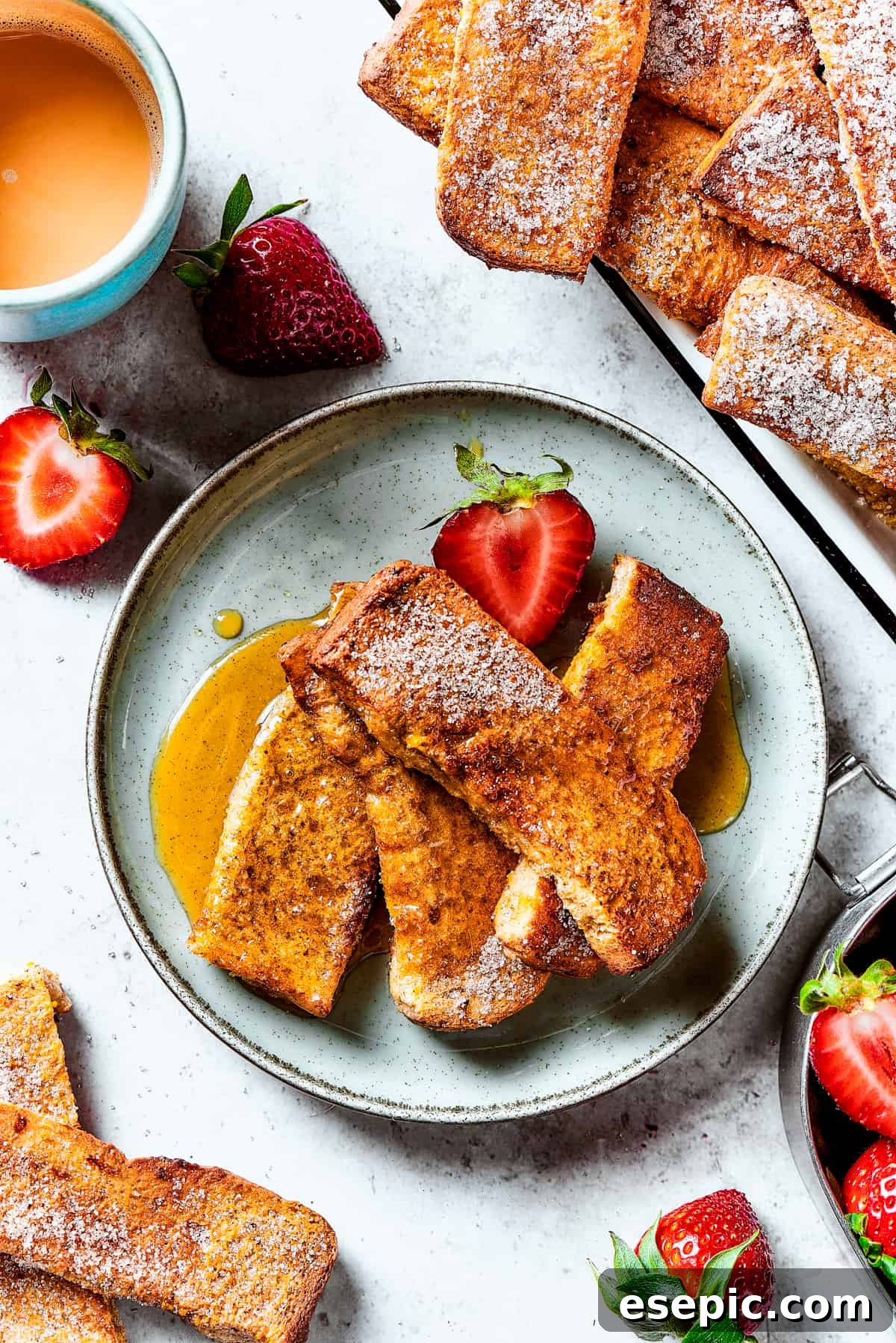 A strawberry-garnished plate of homemade French toast.