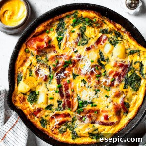 Your Perfect Frittata Recipe 2 overhead shot of a fully-cooked frittata in a cast-iron skillet.