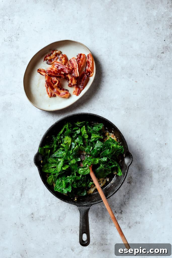 Spinach, Bacon, and Potato Frittata is a healthy, farmhouse-style dinner that's easy to make, and loaded with rich flavor. Perfect easy meal! Cooking fresh spinach in a skillet with onion and garlic, wilting down to infuse flavor.