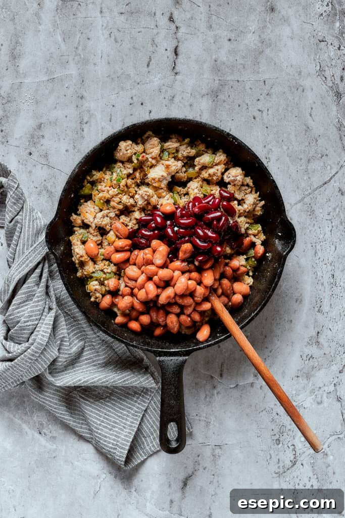 Adding beans to a skillet.