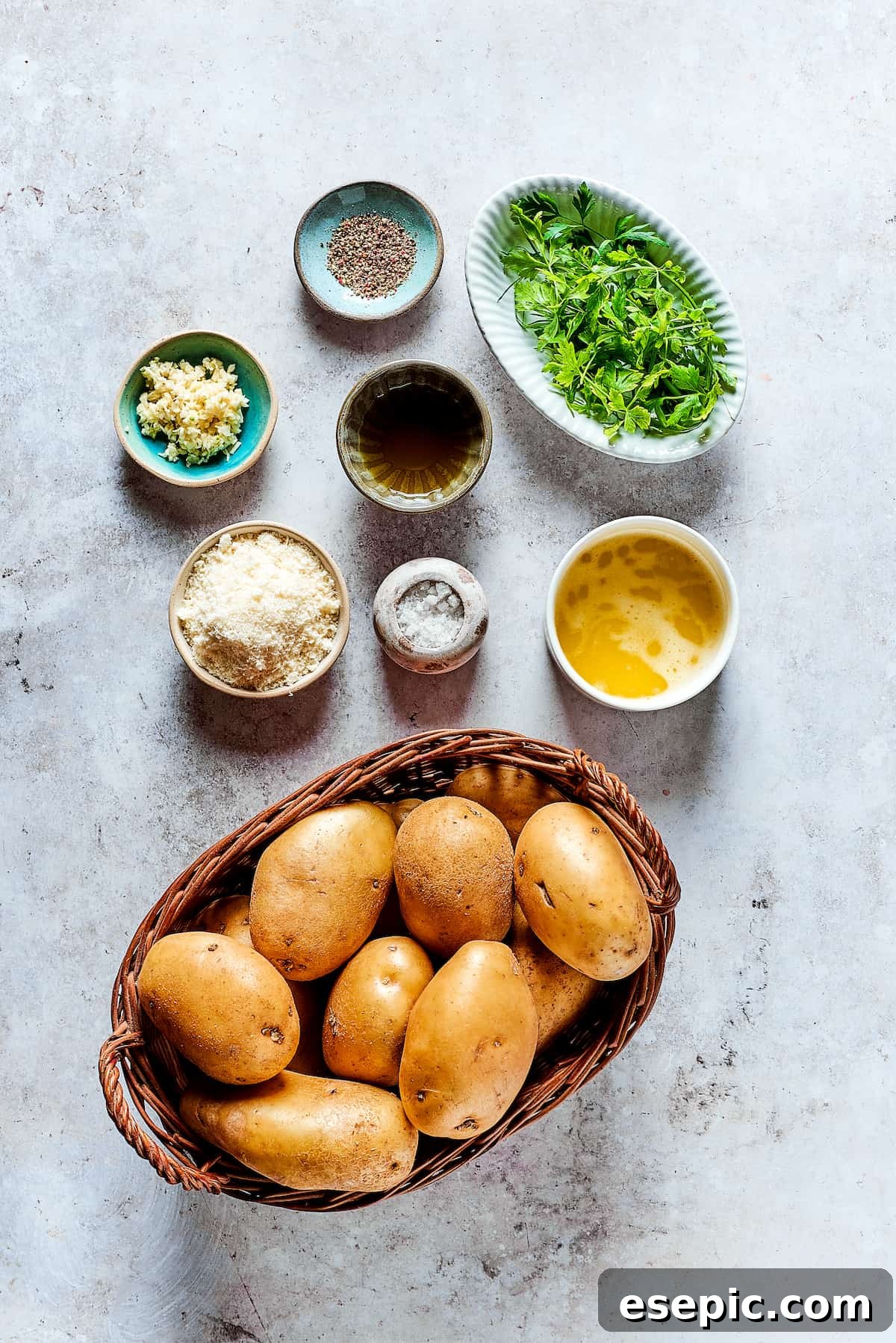Ingredients for garlic fries, arranged in dishes on a work surface.