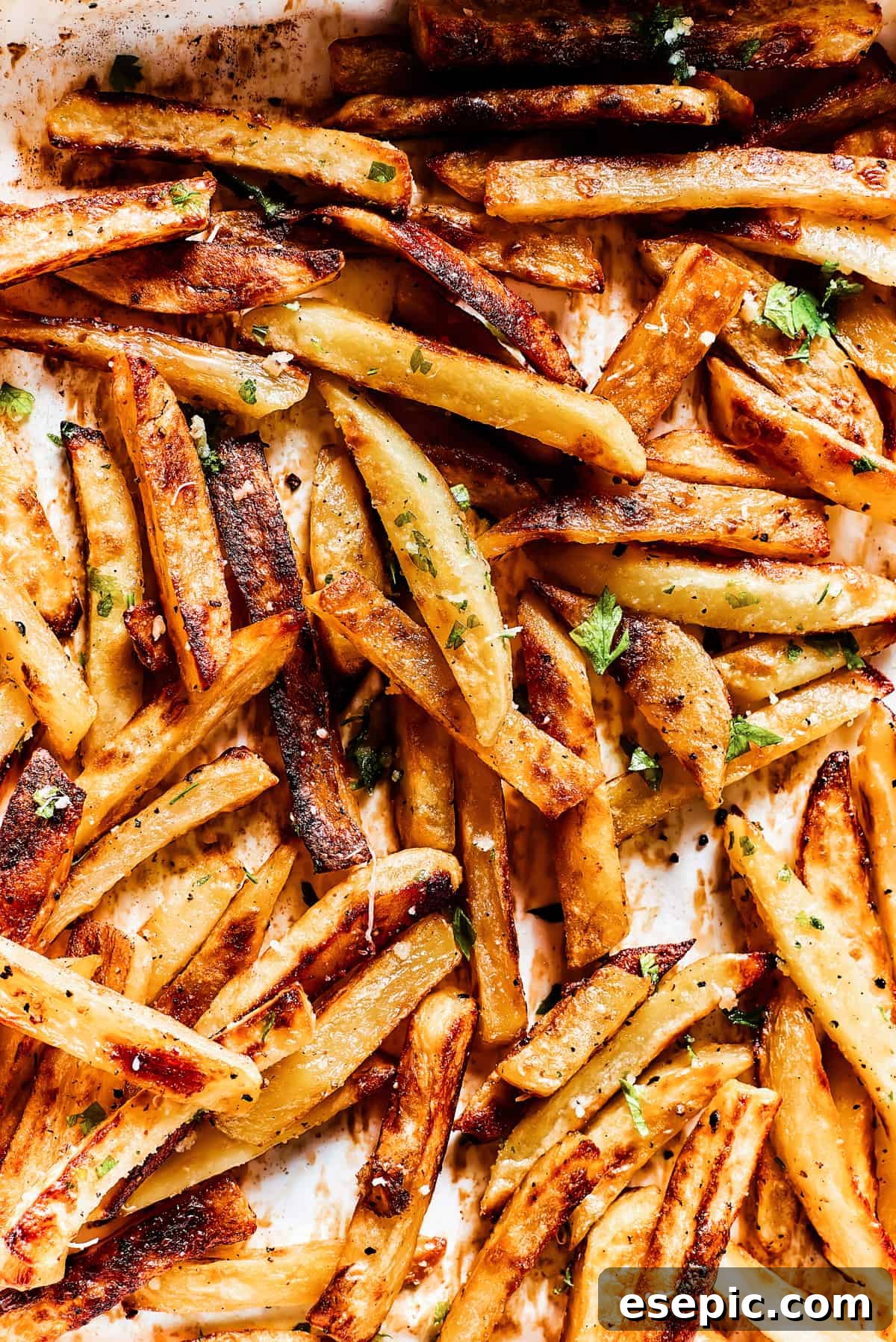 Baked fries drizzled with garlic butter and sprinkled with parsley and parmesan.