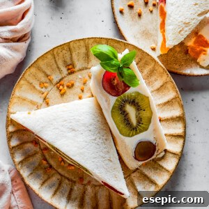 Overhead shot of fruit sandwich halves on a plate.
