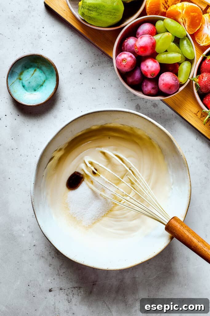 Whipping heavy cream with sugar and vanilla in a bowl using an electric mixer.