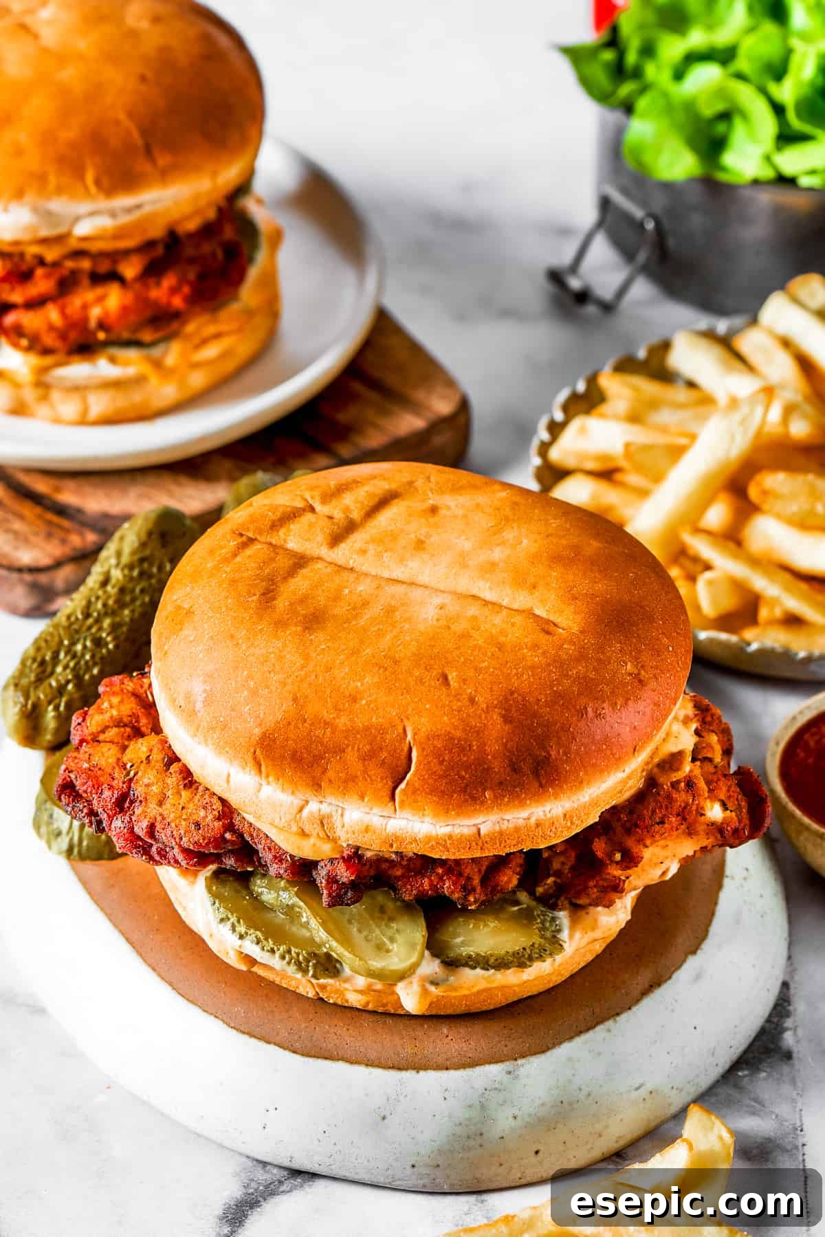 Assembled chicken sandwich with pickles A beautifully assembled chicken sandwich on a soft bun, ready to be enjoyed.