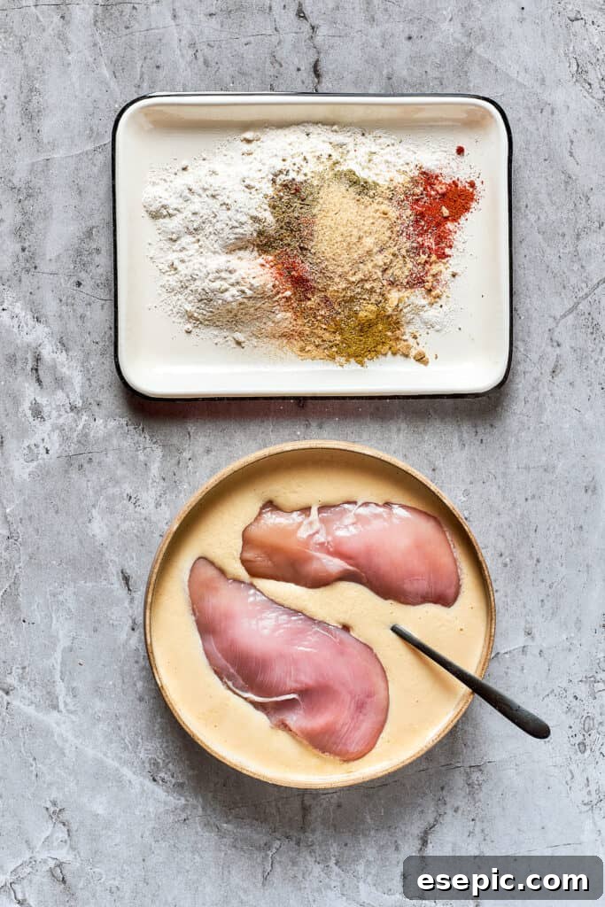 Chicken marinating in buttermilk Chicken breasts soaking in a mixture of eggs and buttermilk, ready for marination.