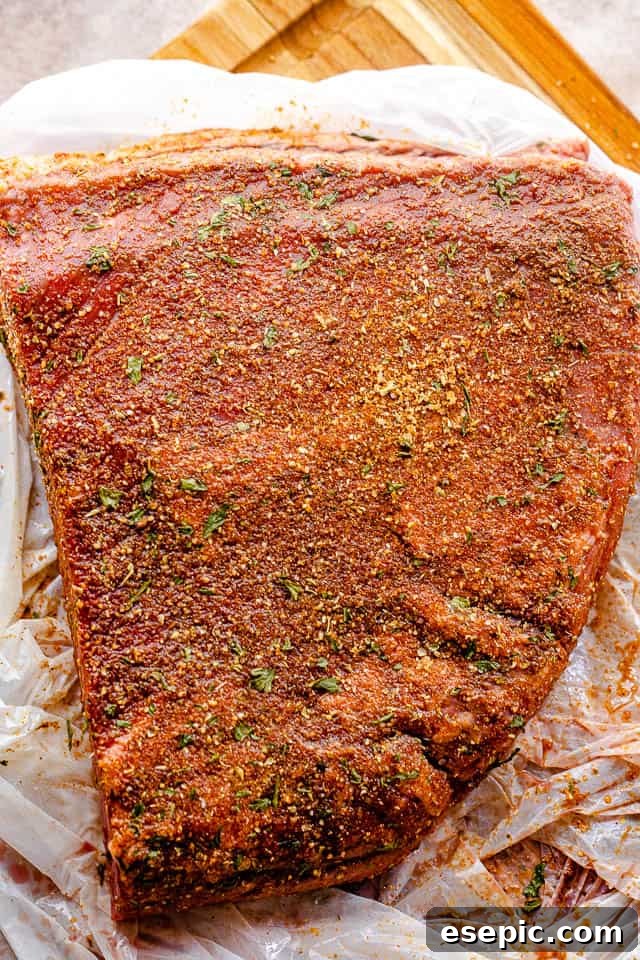 Fall-Apart Slow Cooker BBQ Brisket 5 top shot of seasoned raw beef brisket
