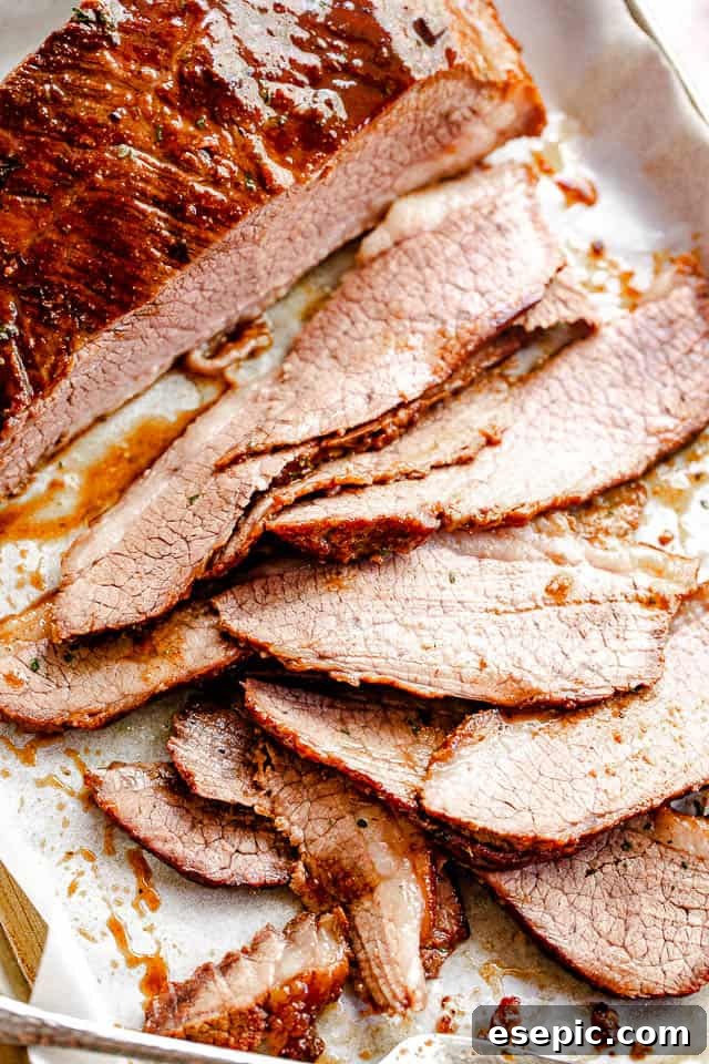 Fall-Apart Slow Cooker BBQ Brisket 6 top view of sliced beef brisket set on parchment paper