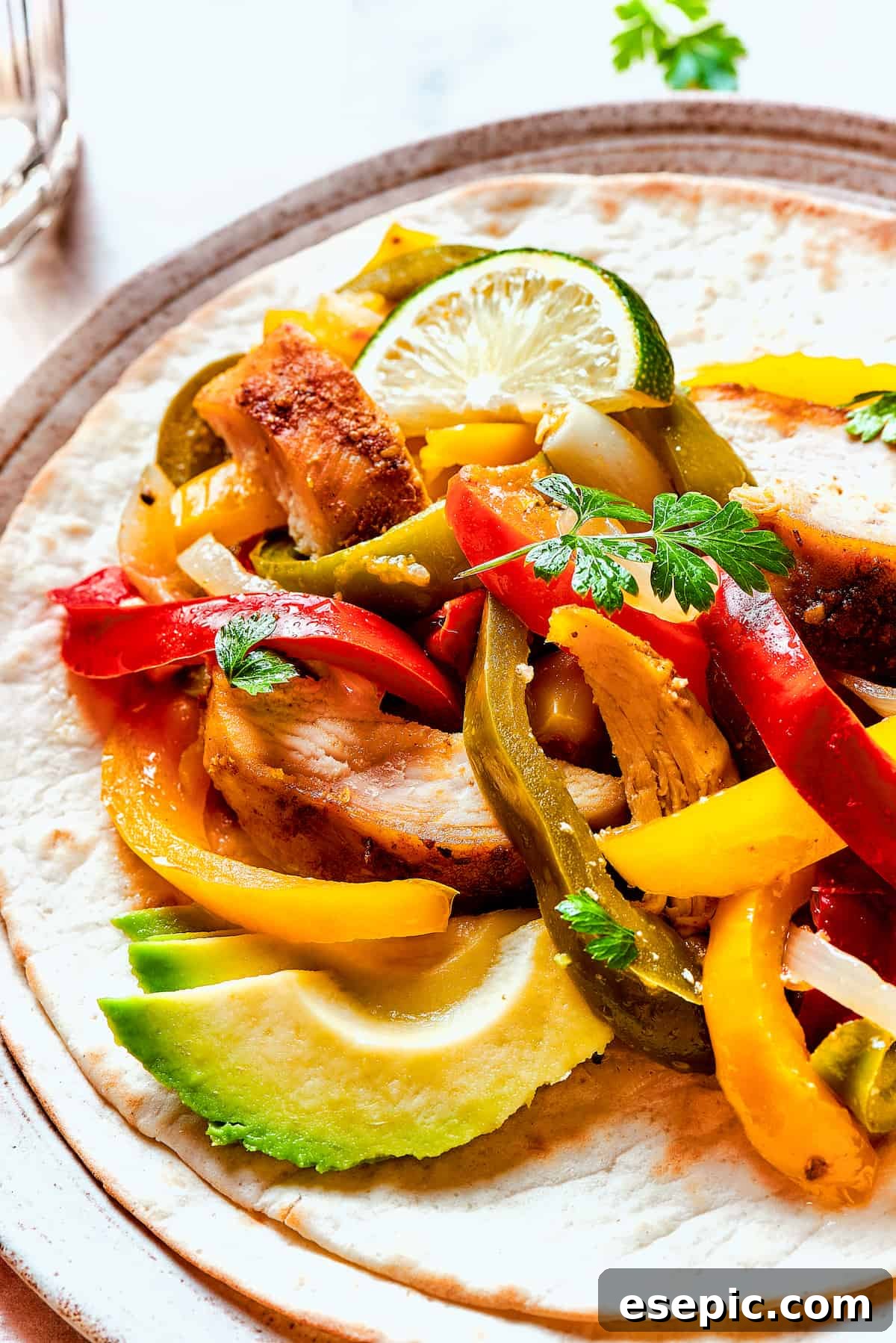Close-up shot of tortillas with fajita chicken.