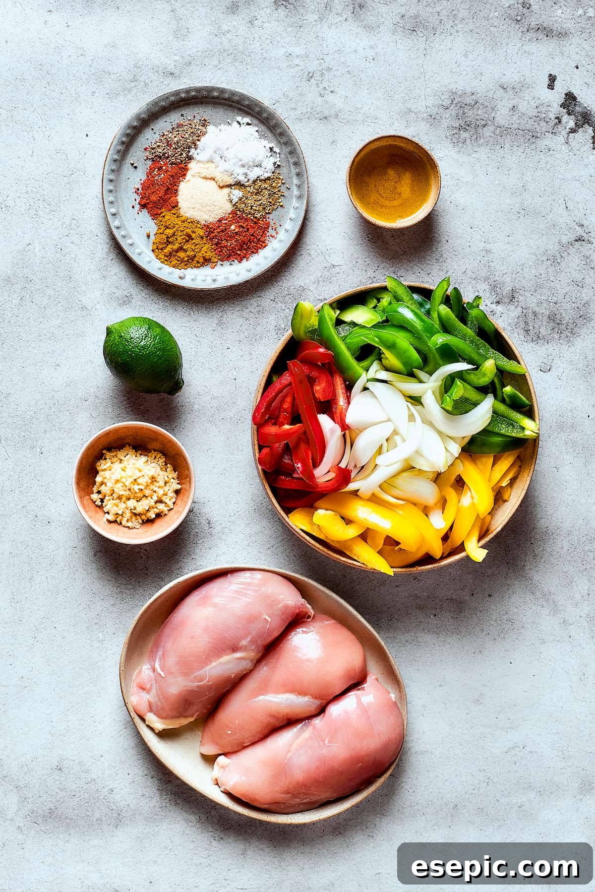 Ingredients for crockpot fajitas arranged on a work surface.