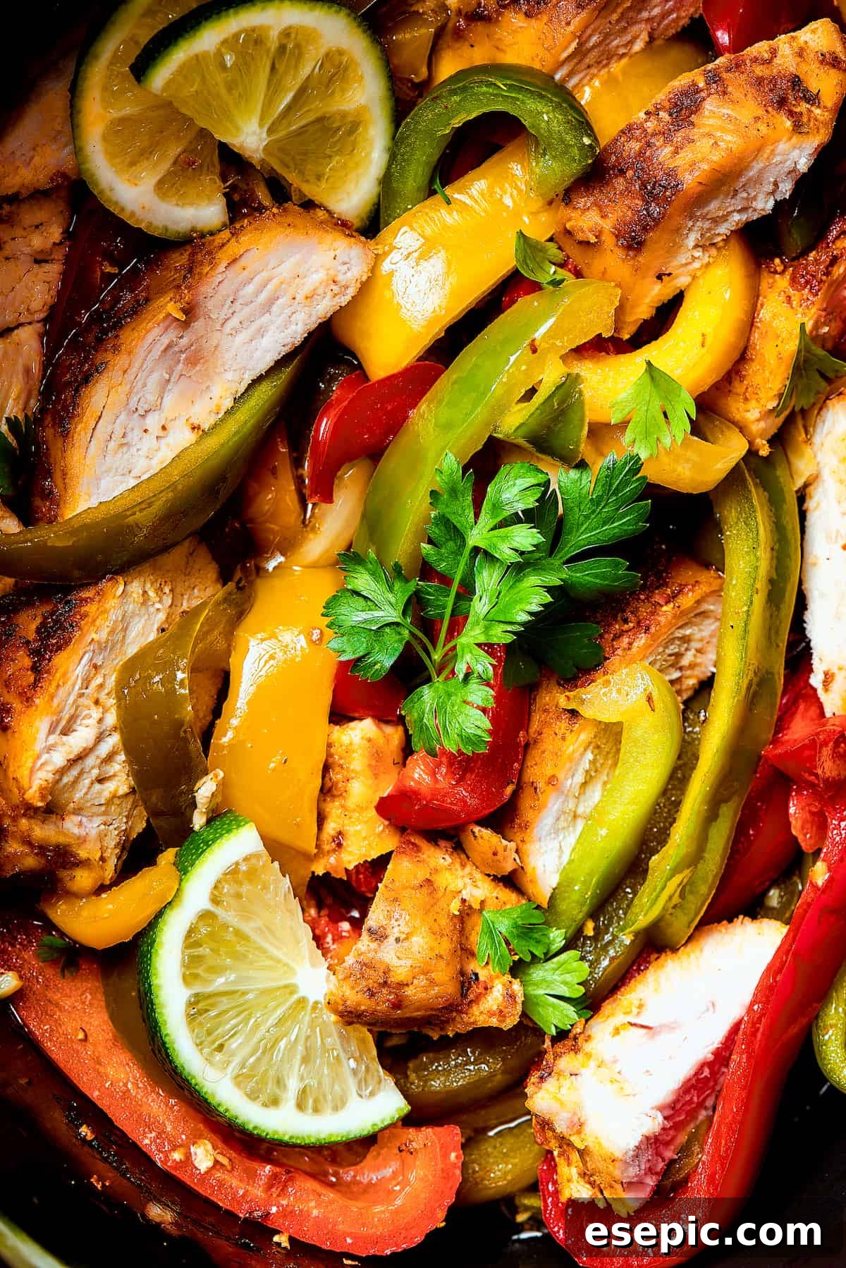Close-up shot of seasoned chicken and veggies in a slow cooker.