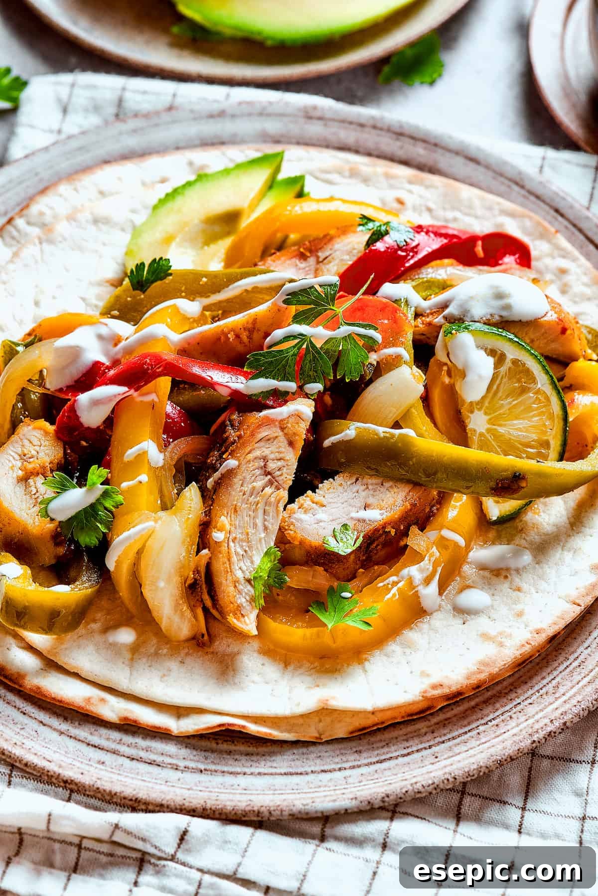 Homemade chicken fajitas with vegetables and lime slices.
