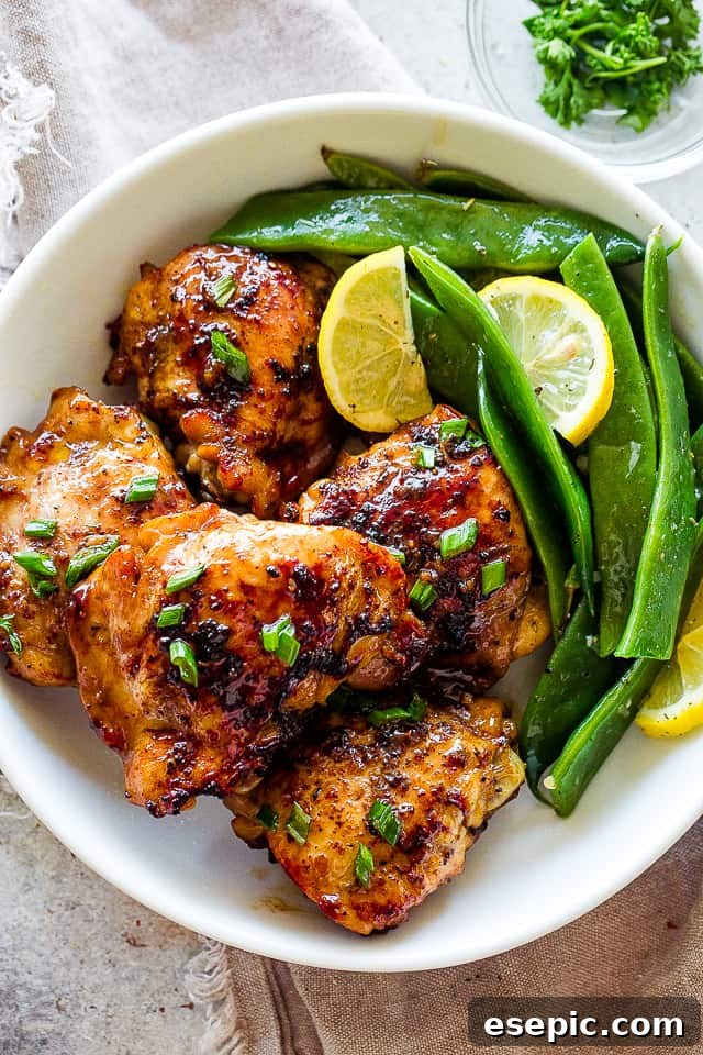 Romano flat beans served on a plate with browned chicken thighs, showcasing a complete meal.