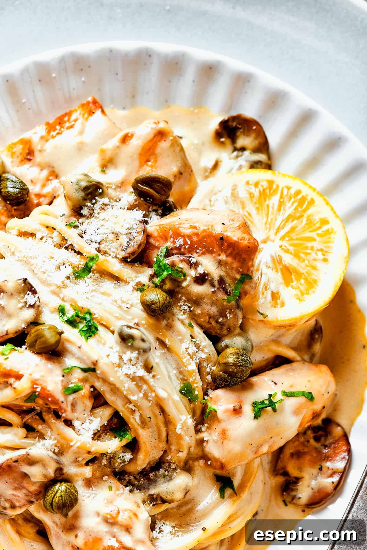 A perfectly plated serving of homemade chicken piccata with pasta, ready to be enjoyed as a gourmet meal at home.
