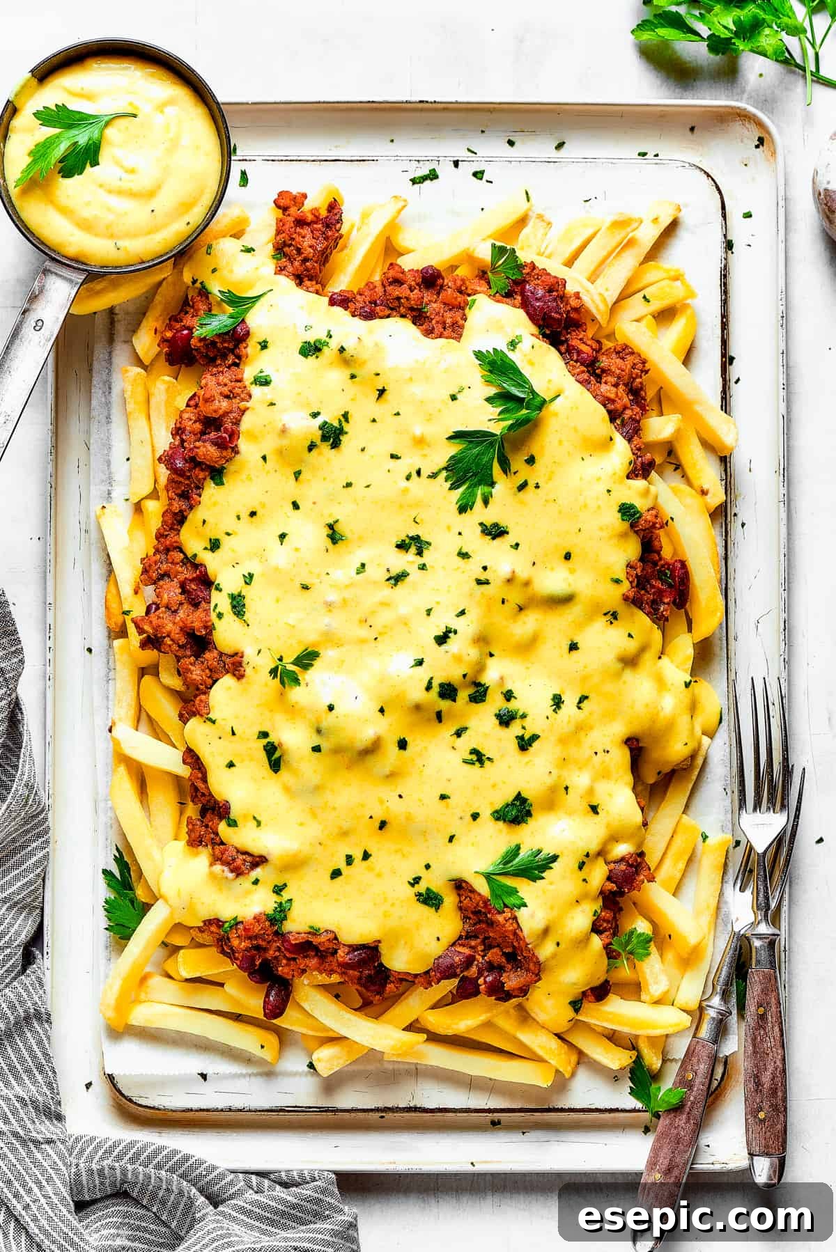 You’ll crave the hot, cheesy goodness of homemade Chili Cheese Fries! This is a fun party appetizer that can double as a family-style meal. Cheese sauce poured over a batch of chili fries.