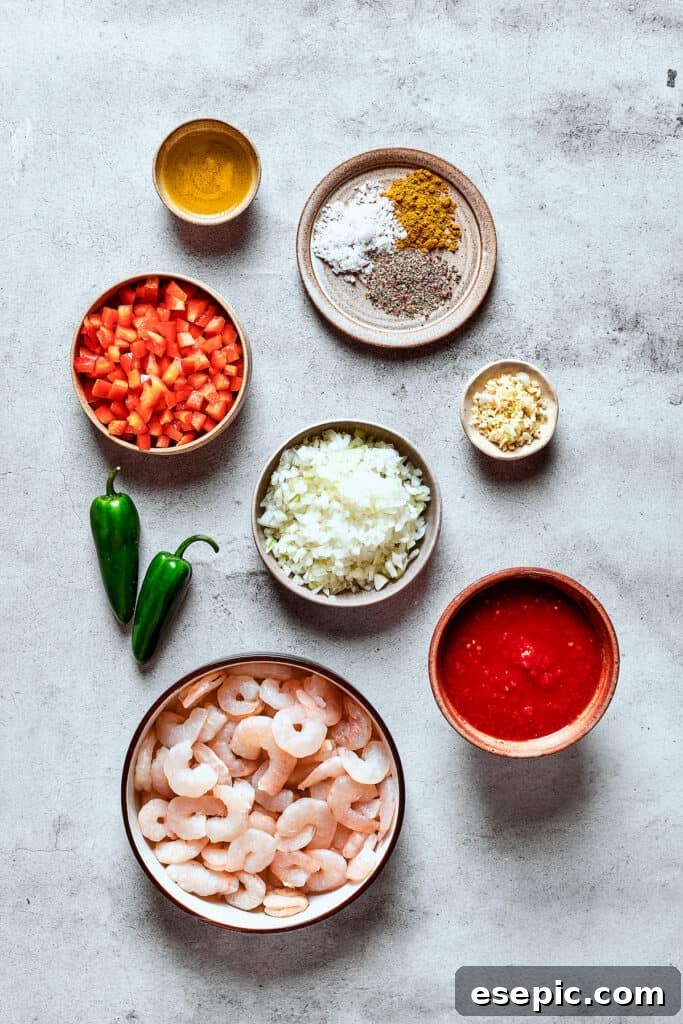 Ingredients for shrimp enchilada filling measured and arranged on a work surface.